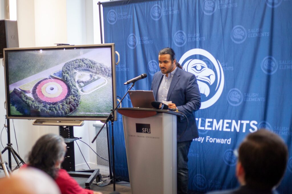 CEO of Salish Elements, Omar Kassem speaks at SFU Harbour Centre event in front of a podium.